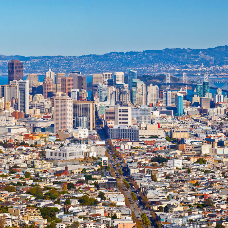 Aerial view of the San Francisco skyline with the Bay Bridge and East Bay hills in the background